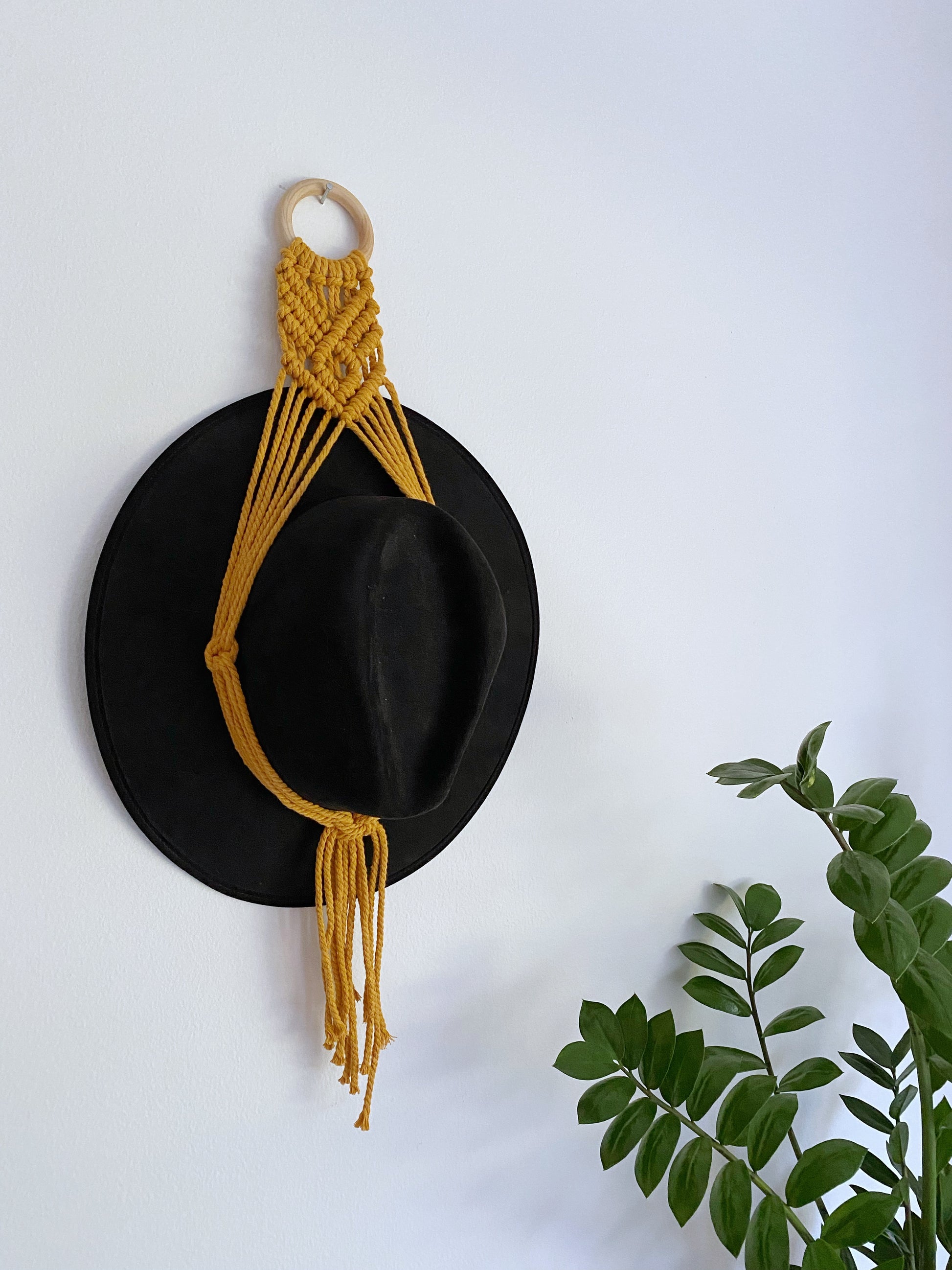 Show off your hat collection and decorate your home with a handmade macrame hat hanger! These hangers are lightweight and easy to hang, and designed to fit a variety of hat sizes. They also make for a unique housewarming gift!
